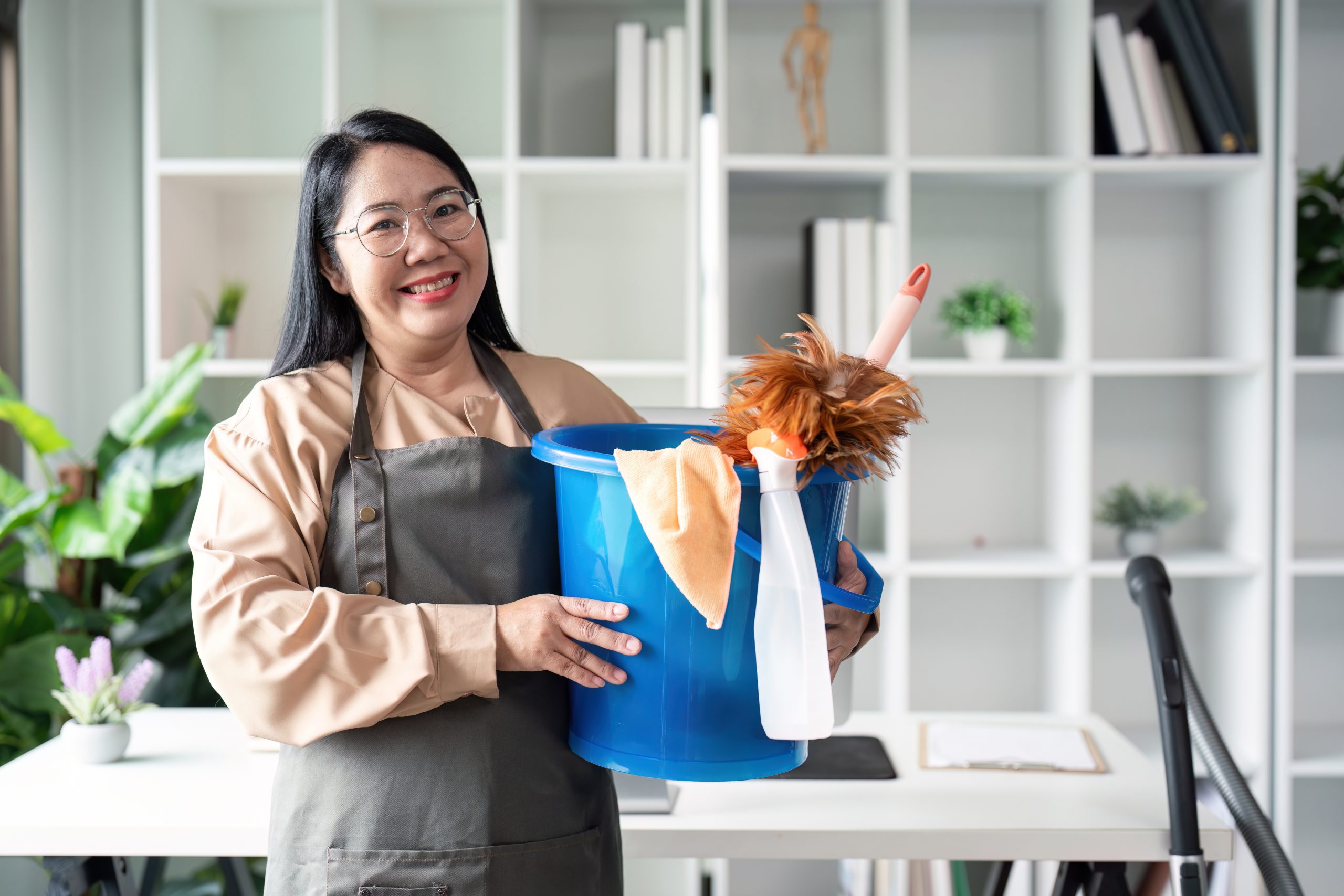Housekeeper cleaning action modern home image of maid with bucket bright environment smiling viewpoint concept of cleanliness